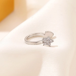Star and heart open silver ear cuff with sparkling zircon inlay on white satin