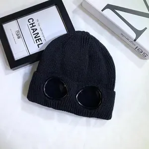Close-up of black knit beanie with integrated protective goggles for outdoor skiing