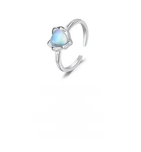 Detailed macro of S925 silver ring featuring leaf carvings and a blue moonstone