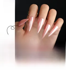 Detailed view of long stiletto press-on nails in glossy pastel pink finish