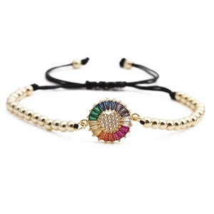 Adjustable gold bead bracelet featuring a rainbow zircon sunflower charm on black cord