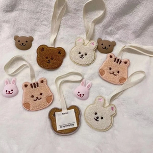 Detail of plush bear, rabbit, and tiger name tags with transparent ID card slots