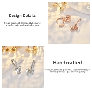 Macro detail of heart hoop earrings with rose gold and silver cubic zirconia stones