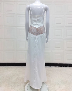 Detailed view of the white satin evening dress with lace patchwork on the back waist