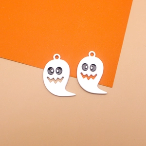 Close-up of Halloween ghost charms with white enamel coating and black eye details