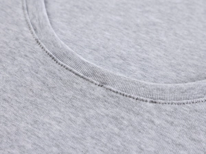 Macro detail of the premium stitching and grey marl knitted fabric on the U-neck top