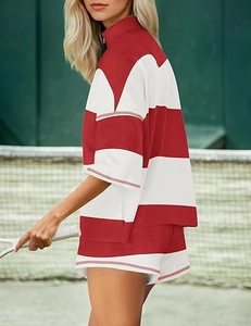 Detail of red and white striped women's sports set with half-zip top and matching shorts