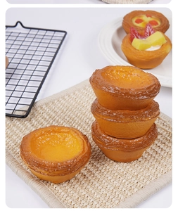 Detailed view of 7.5cm soft PU egg tart model with realistic flaky crust and fruit toppings