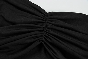 Close-up of the elegant ruching detail on high-stretch black knitted fabric material
