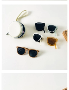 Detailed view of foldable kids sunglasses in various colors with round zipper storage cases