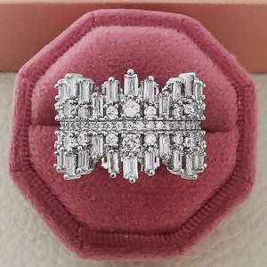 Luxurious wide silver ring with baguette and round cut zircon in a pink velvet jewelry box