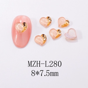 Macro view of 8x7.5mm pink heart nail art charms with gold trim and model MZH-L280