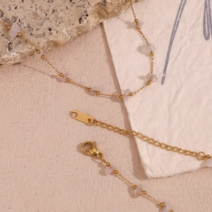 Detail view of 18K gold plated chain with natural pink crystal stones and lobster clasp