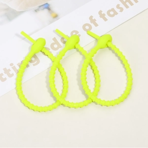 Close-up of three neon green adjustable silicone cable ties with non-slip tooth design