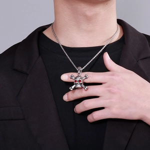 Close-up of hip hop skull pendant with red stone eyes on stainless steel rope chain