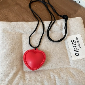 Detailed macro view of the 3D red heart pendant on a black adjustable cord necklace