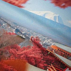 Close-up of bohemian tapestry fabric showing woven texture and Mount Fuji landscape print