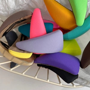 Colorful sponge-wrapped BB hair clips in vibrant fabric finishes stacked in a wire basket