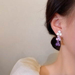 Model wearing vintage purple gradient floral earrings with pearls in a side profile view