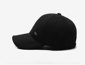 Detail view of the black wool baseball cap with silver mountain metal logo on the side