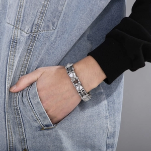 Close-up of punk skull bike chain bracelet in antique silver finish worn by a model
