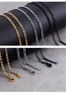 Detail view of Figaro chain links in gold, silver, and black with lobster clasp