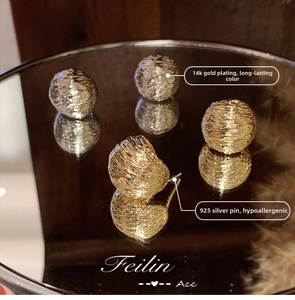 Detail of 14k gold plated textured spherical earrings with anti-allergy 925 silver needles