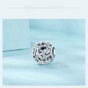 Detailed macro view of S925 sterling silver hollow vine bead with sparkling zircons
