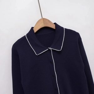 Classic dark blue knit polo cardigan with white wavy scallop trim and black buttons