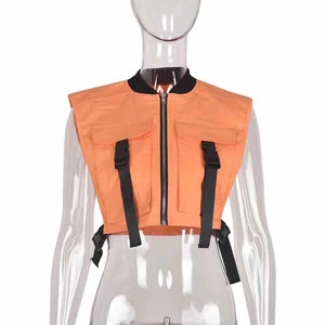 Detail of orange utility vest featuring tactical pockets with black buckles and zip front