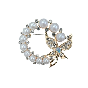 Elegant gold-tone butterfly and pearl wreath brooch with sparkling rhinestones and crystals