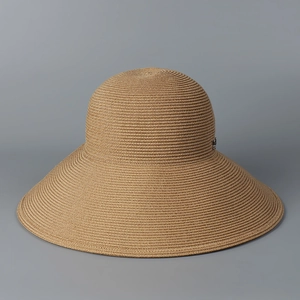 Detail of light brown straw sun hat featuring neat horizontal weave and metal buckle