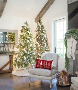 Christmas lumbar pillow with red trees on grey armchair in festive living room setting