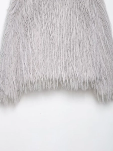 Close-up of grey faux fur coat showing thick plush texture and soft material detail