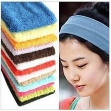 Macro detail of various colorful soft organza scrunchies and a light blue hair tie worn