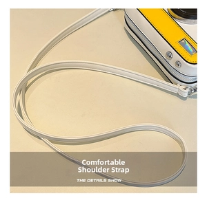 Detail showing high-quality white leather shoulder strap and silver metal buckle on camera bag