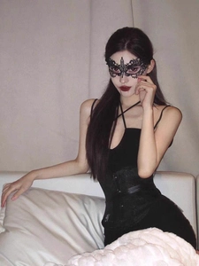 Detailed close-up of intricate black lace butterfly mask for masquerade cosplay