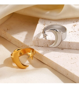 Polished gold and silver stainless steel star and moon rings on elegant white stone base