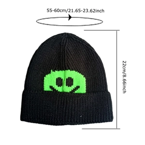 Black knit beanie with neon green smiley face patch and detailed size specifications