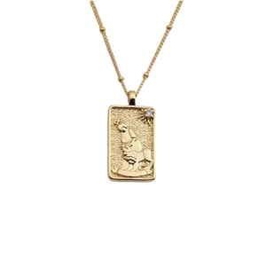 Gold geometric necklace with embossed lion and figure pendant on a dainty beaded chain