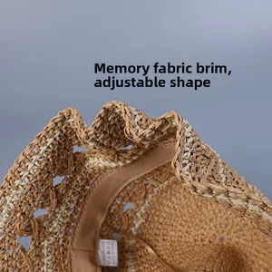 Detail of hand-woven straw sun hat showing adjustable wire rim and internal sweatband