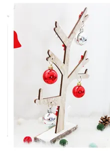 Close-up of minimalist wooden Christmas tree stand with red and silver holiday ornaments