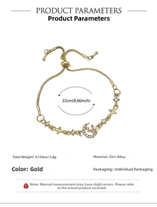 Detail of adjustable gold star and moon bracelet with butterfly and white rhinestones