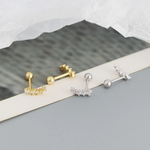 Detailed close-up of gold and silver S925 sterling silver screw back stud earrings
