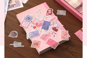 Close-up of pink stationery stickers on a vintage notebook for journaling decoration