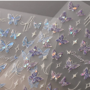 Detailed macro view of holographic butterfly nail art stickers with purple laser finish