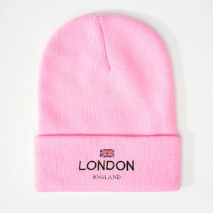 Pink knitted beanie hat featuring Union Jack embroidery and London text on front