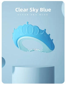 Macro detail of sky blue crown-shaped baby shower cap with adjustable strap and GOOD logo