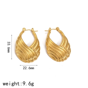 Macro shot of gold stainless steel earrings with wavy texture showing 33.6mm height scale