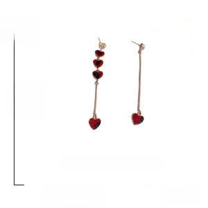 Detail showing asymmetrical heart earrings with red and black crystals and 7.2cm length dimensions